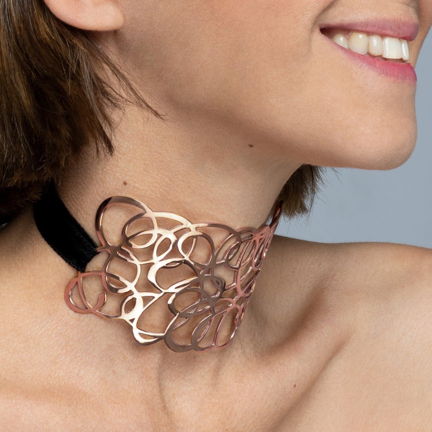 Modelo con Collar tipo "choker" calado de Oro Vermeil rosa con cinta ajustable de algodón.