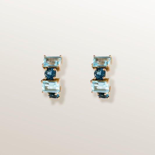 Pendientes tipo medio aro o criolla eternity de oro rosa con topacios azules London blue octogonales y redondos.